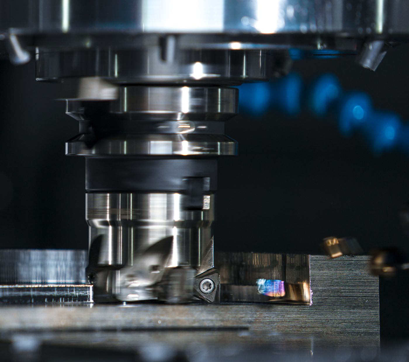 A milling cutter shaping a metal workpiece
